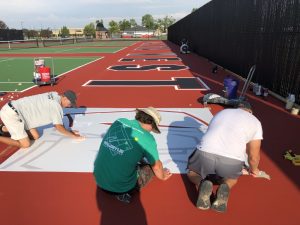 Lakato West Tennis Courts Painting the Logo